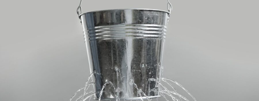 Leaking bucket showing breakdowns in sales funnels in online marketing